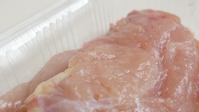 Packed and frozen poultry meat close-up 4K 2160p 30fps UltraHD panning  video - Raw chicken breasts in a box slow pan 3840X2160 UHD footage