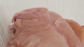 Frozen chicken breasts in a box close-up 4K 2160p 30fps UltraHD panning video -Box with poultry meat 3840X2160 UHD footage