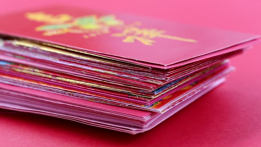 Chinese New Year : Concept of people giving red envelope with Chinese language means of lucky and wealth on red background