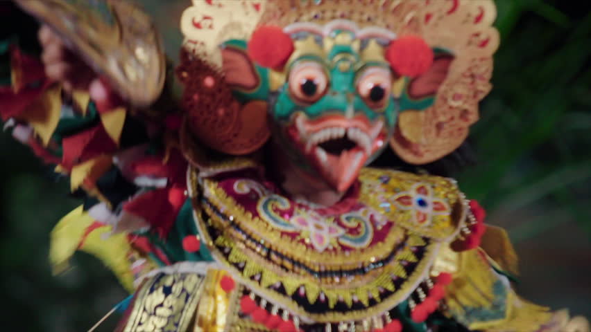 10 march 2015 Indonesia, Bali, Ubud. Balinese performing artistic dance in ceremonial traditional colorful costume using hands and fingers, close-up man portrait dancing in colorful mask