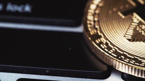 Crypto currency Gold Bitcoin - BTC - Bit Coin. Bitcoins on the laptor keyboard. Slider shot.