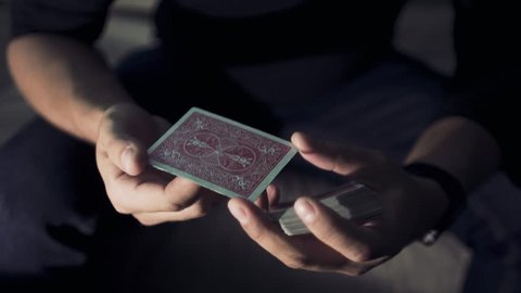 Close-up of a Magician's Hands Performing Card Trick. Card spinning on my finger.