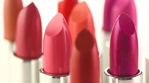 Lipstick. Fashion Colorful Lipsticks rotated over white background. Lipstick tints palette, Professional Makeup and Beauty. Beautiful Make-up concept. Lipgloss. Lipsticks closeup