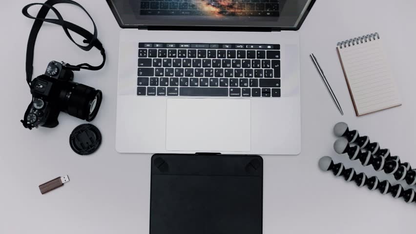 Man is working laptop computer and graphic tablet. Designer flat lay top view workplace