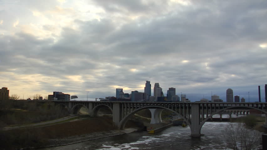 timelapse shot of downtown Minneapolis, MN at dusk with the Mississippi river in