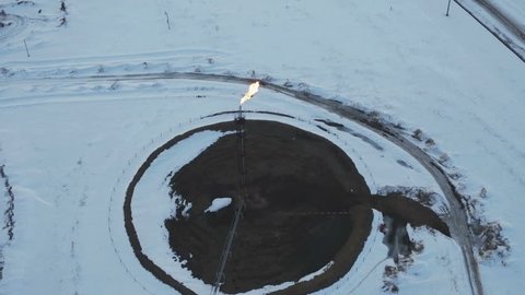 Aerial View Gas burning from flare structure in oilfield Winter