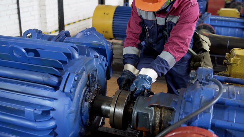 Worker repairing pipeline in pump station at oil production department | Shutterstock HD Video #1007093083