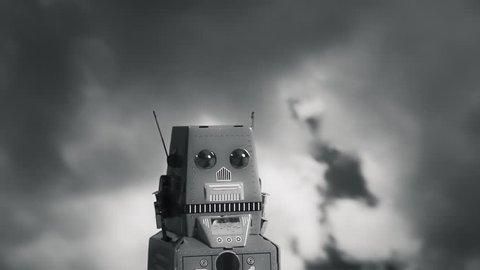 A tin toy robot standing still in front of dark ominous clouds. Film noir style.
