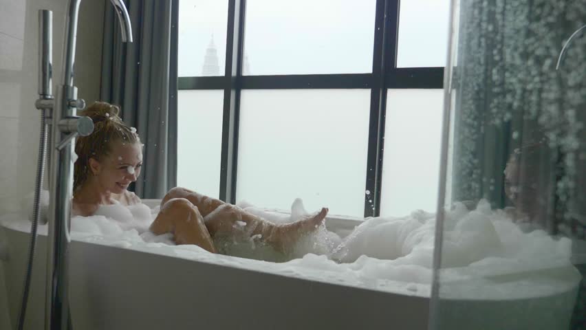 Beautiful woman relaxing in bubble bath lying in bathtub. Beauty care, leisure activity and healthcare concept. Royalty-Free Stock Footage #1007097664