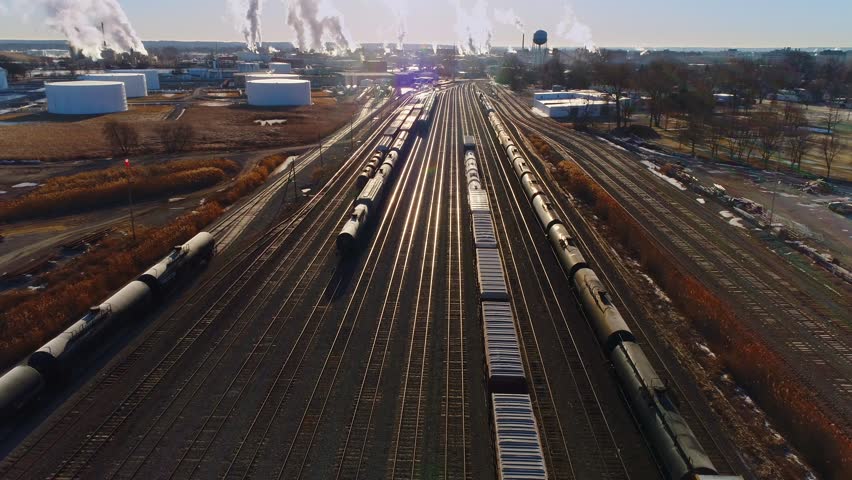 Looking down on industrial railroad train yard, many trains, tracks. Dynamic aerial view.
 Royalty-Free Stock Footage #1007108065