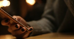 technologies, people, video, movie, 4k and creative concept - Young Caucasian woman using smartphone in a cafe . Close up shot of hands typing on a touch screen smart phone. texting on phone