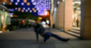 art, dance,lifestyle, people, 4k concept - Breakdancer in the streets. Active young male dancing break dance, hip hop style on the city. blurry video