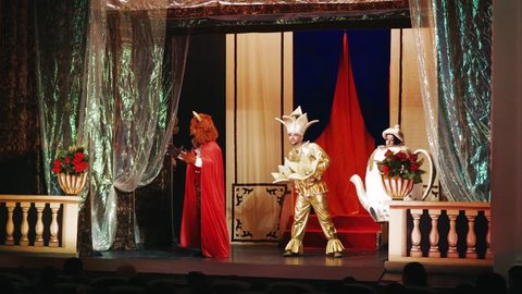 actors of the theater on stage - puppet show for children - disguised actors in beautiful costumes during the production of the play