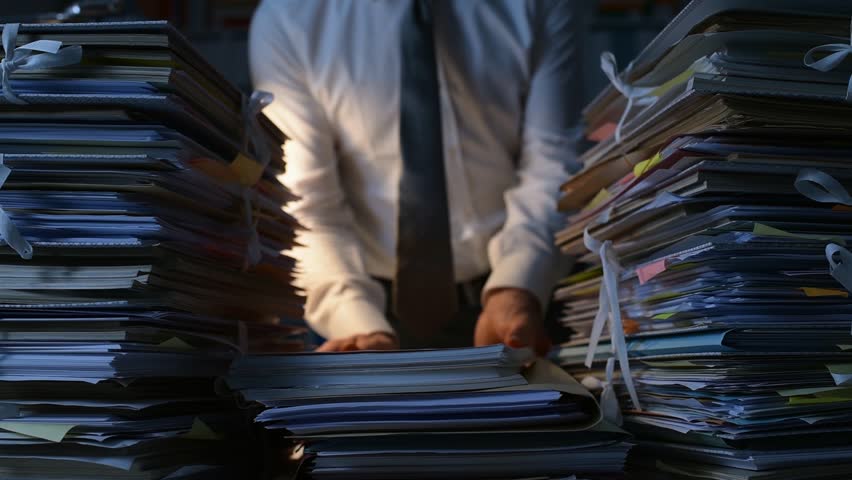 Office clerk stacking paperwork and files on the desk late at night, work overload and bureaucracy concept Royalty-Free Stock Footage #1007116480