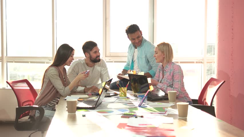 Creative teamwork in office. Coworkers discussing startup project on paper. | Shutterstock HD Video #1007117992