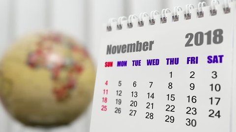 Motion of November 2018 calendar with blur earth globe turning background