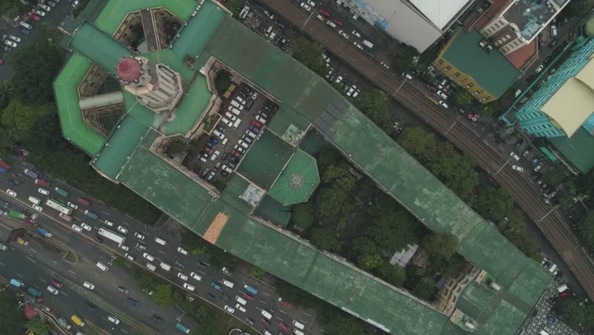AERIAL: Top Shot of the Beautiful Historic Manila City Hall of the Philippines. Coffin like shape with three-faced clock. Decades old building and largest clock tower in the Philippines. Cinematic 