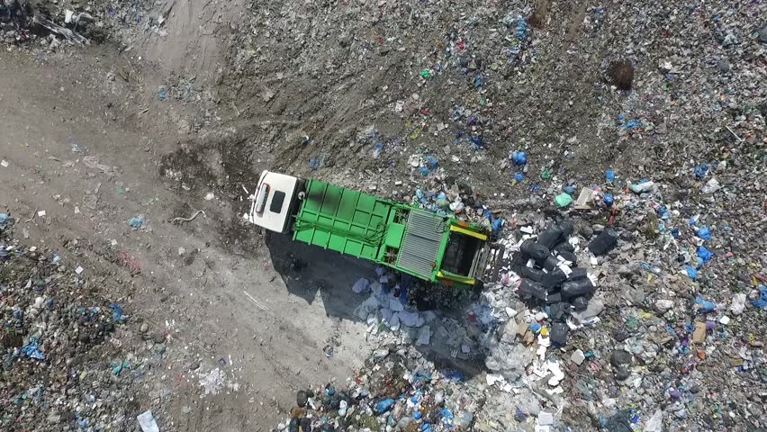 Garbage truck spills rubbish in a dump, aerial view Royalty-Free Stock Footage #1007133385