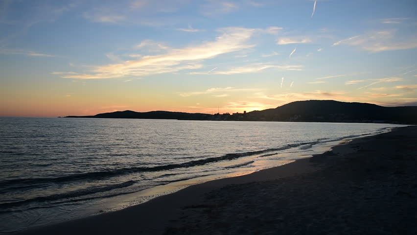 Colorful sky over Alghero sea at sunset. Sardinia, Italy