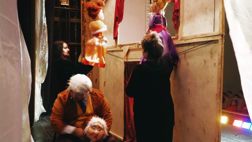 puppeteer manages puppets behind scenes stage Stock Footage Video (100% ...