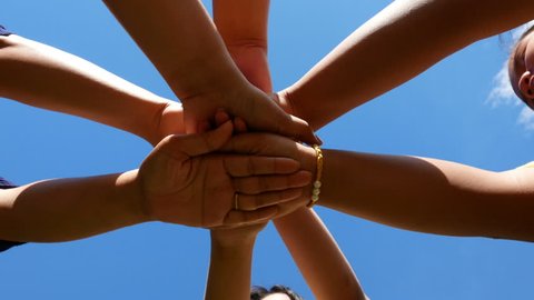 Many hands holding together on blue sky background.concept successful team 