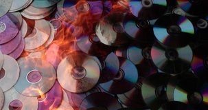 compact discs melt under the powerful hot flame of fire
