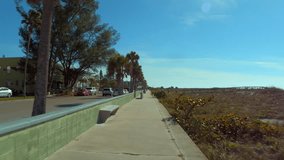 Motion video tour St Pete Beach walkway by dunes