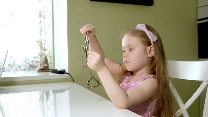 A gerl unravels a metal puzzle, coaches brain activity 4k