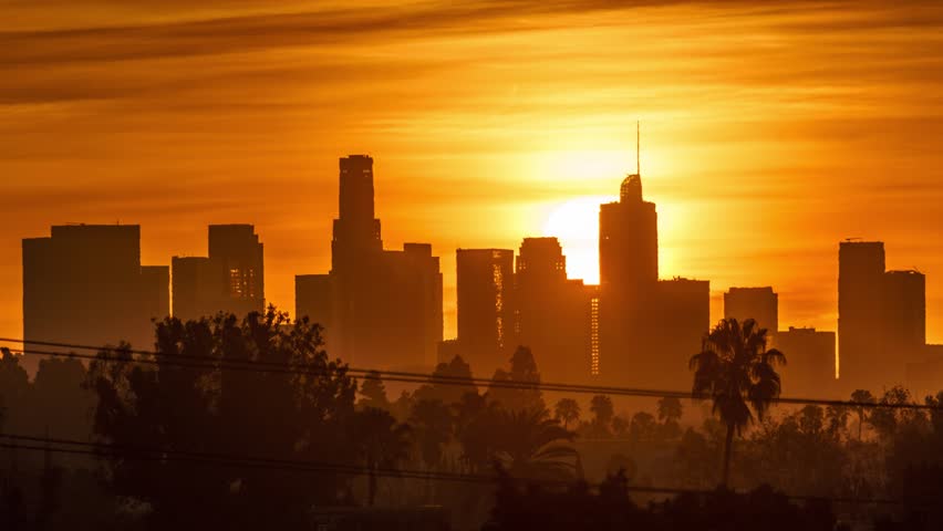 Sunrise sun rising behind downtown Los Angeles skyscrapers, beautiful city skyline. 4K UHD timelapse. | Shutterstock HD Video #1007165227