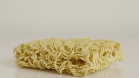 Uncooked Chinese noodles on white background 4K 2160p 30fps UltraHD tilting footage - Instant staple food block  slow tilt 3840X2160 UHD video