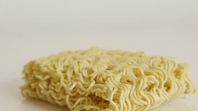 Instant staple food block 4K 2160p 30fps UltraHD tilting footage - Uncooked Chinese noodles on white background slow tilt 3840X2160 UHD video