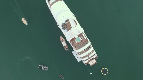 Top down aerial view of luxury super yacht or mega-yacht docked in harbor