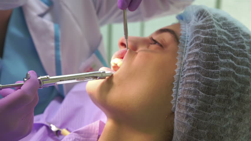 the dentist is making anesthesia to the patient  Royalty-Free Stock Footage #1007170018