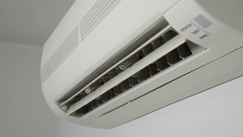 Side view at an operating air conditioner.
Video footage showing moving air conditioning elements.