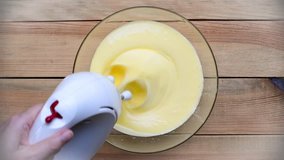 Seamless loop, Top view of hand holding electric mixer mixing dough - HD video