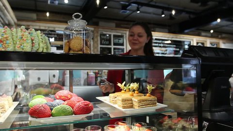 Woman serving client in confectionery shop