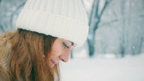 footage beautiful happy smiling woman at cold and snowy winter walking at park. Central Park is one of the largest in the US