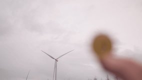 Gold BTC bitcoin cryptocurrency with renewable energy wind turbines in background  - Powered by Shutterstock - Get 15% off with code: PIKWIZARD15