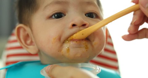 Baby Eating Puree Food First Time Stock Footage Video (100% Royalty