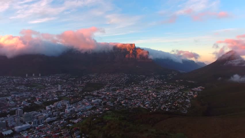 Aerial view from drone of Table Mountain in Cape Town South Africa at sunrise with clouds.
