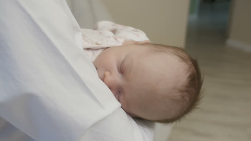 Baby is sleeping while mom is holding him | Shutterstock HD Video #1007203864