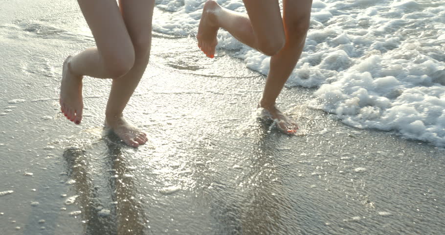 Two girlfriends are actively running along the coast. The close-up view of the bare feet. No face, 4k. | Shutterstock HD Video #1007204605