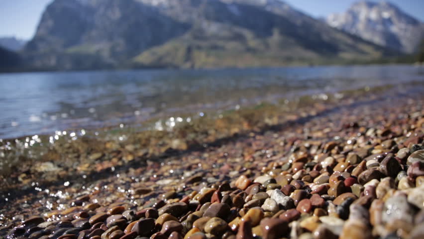 Close Up Waves of Water Crashing onto Rocks and Shore of Mountain Lake Jenny