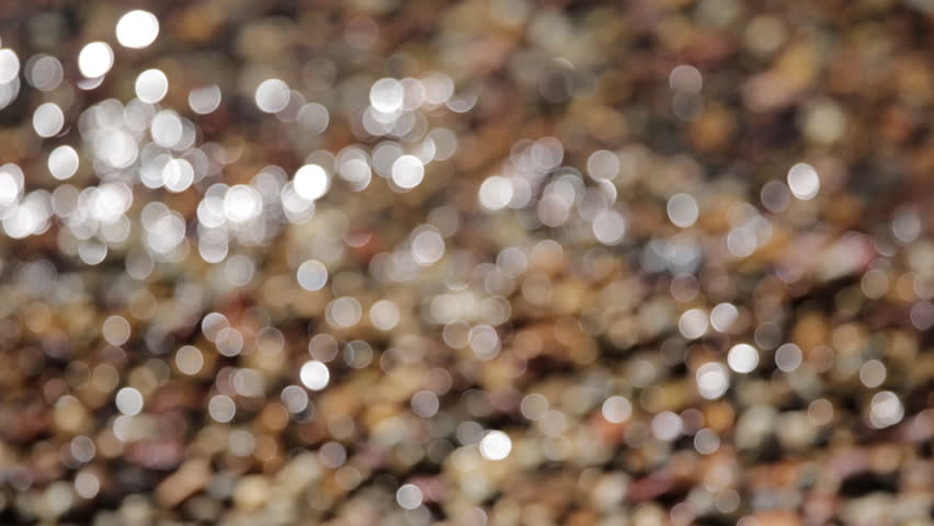 Close Up Waves of Water Crashing onto Rocks and Shore of Mountain Lake Jenny