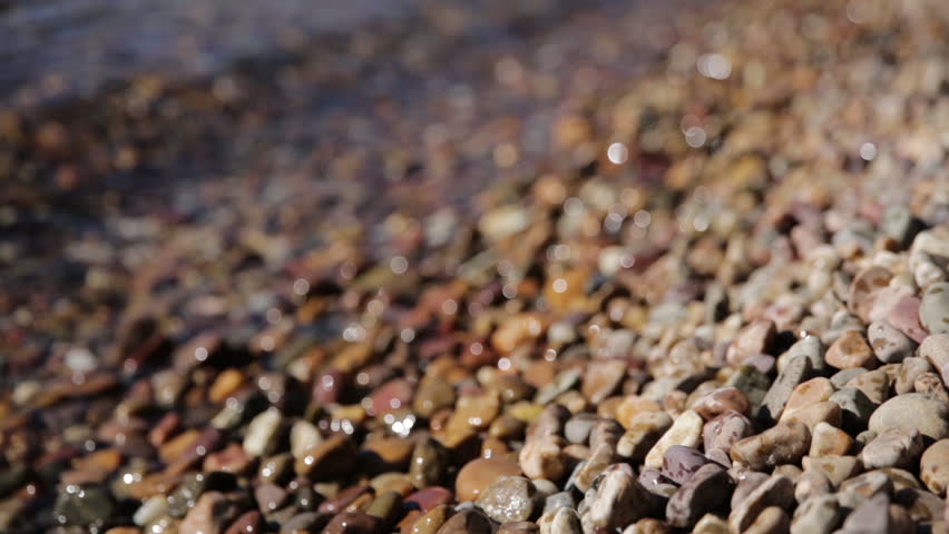 Close Up Waves of Water Crashing onto Rocks and Shore of Mountain Lake Jenny