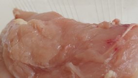 Slow pan on frozen poutry 4K 2160p 30fps UltraHD video - Chicken breasts packed in a box 3840X2160 UHD panning footage