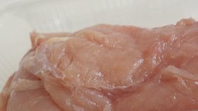 Raw chicken breasts in a box close-up  4K 2160p 30fps UltraHD panning video - Box with poultry meat slow pan 3840X2160 UHD footage