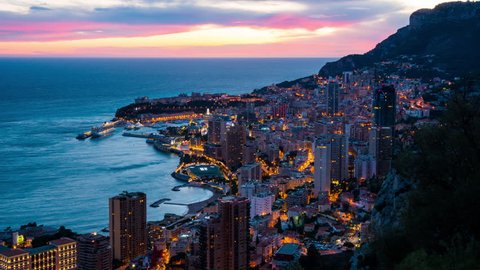 Monte Carlo, Monaco: urbanscape with city and marina in the evening. Panoramic view on Monte-Carlo from evening to night time lapse.