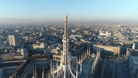 Aerial drone footage of famous statue on cathedral Duomo of Milan Italy // no video editing