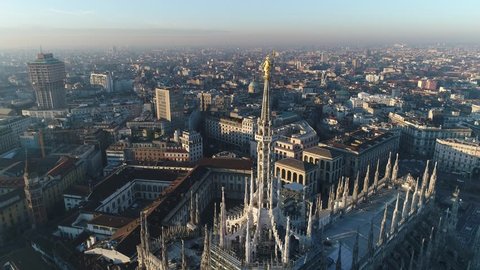 Aerial drone footage of famous statue on cathedral Duomo of Milan Italy // no video editing